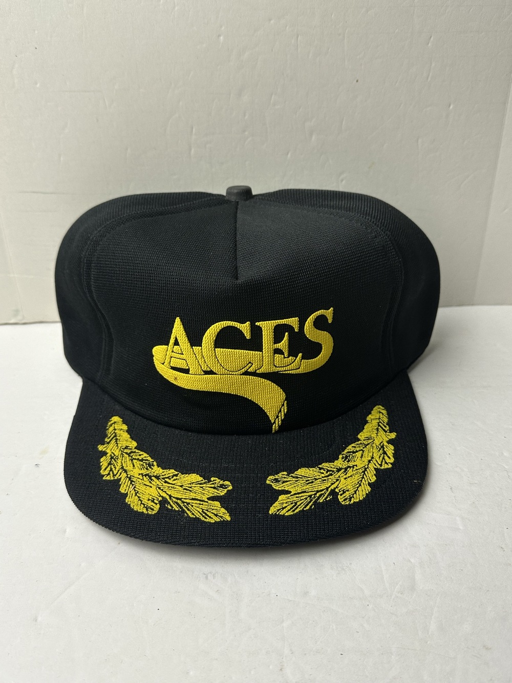 Vtg 80s Aces black snapback cap with gold embroidery and green underbrim